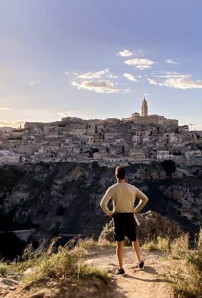 Italy Puglia man overlooking town