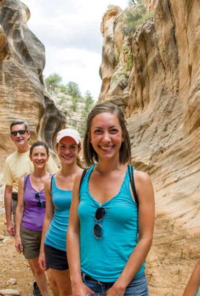 Women taking a selfie with her family in a canyon.