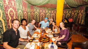 A group enjoying a meal in a tent.