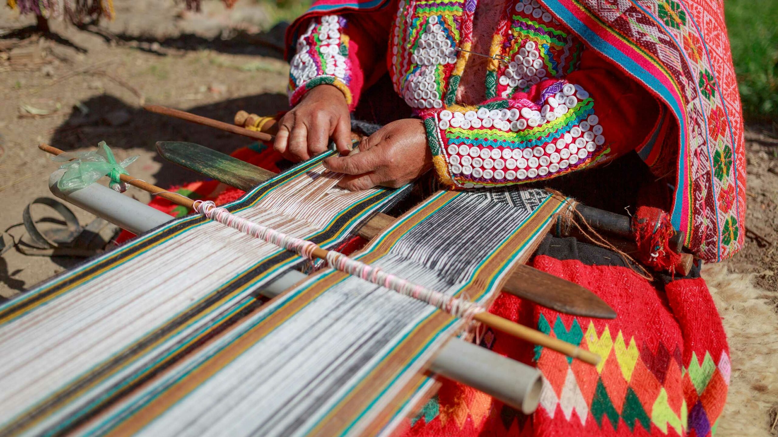 A woman weaving traditional scarves in Peru.