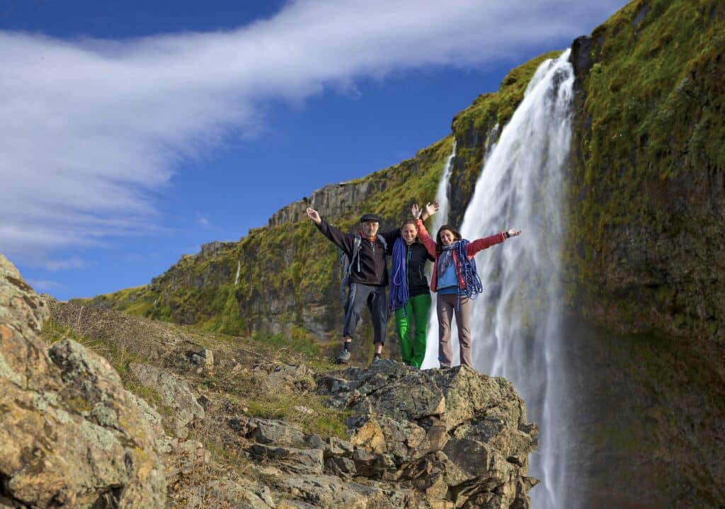 Iceland family trip standing in front of a glacier