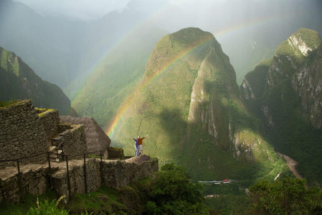 Visitors at Machu Picchu, Peru with arms outstretched