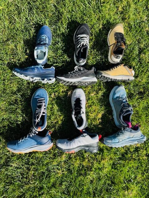 6 pairs of hiking shoes agains the grass to compare