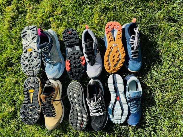 Series of hiking shoes in the grass to compare
