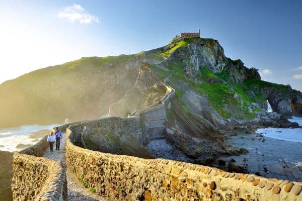 Coupe walking on path by the sea in Basque