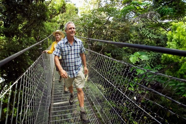 Couple walking on a bridge in the jungles of Costa Rica