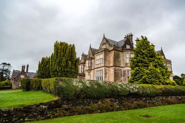 The impressive Muckross House in Ireland set against greenery