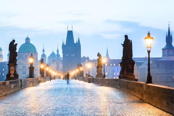 Walking along a bridge in Prague at dusk