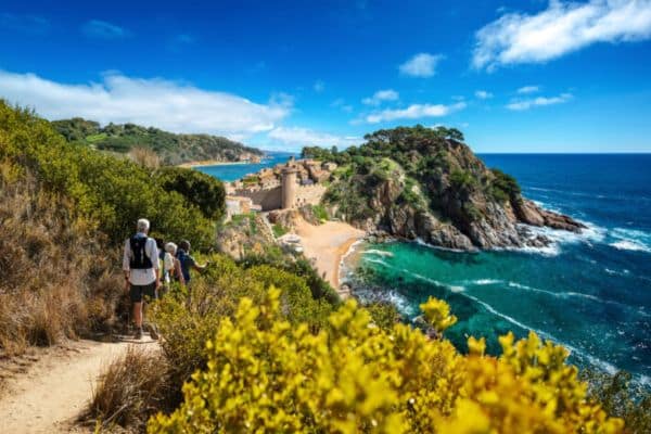 Group walking along a seaside path 