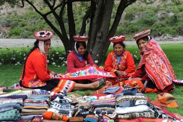 Peruvian woman weaving colorful fabrics