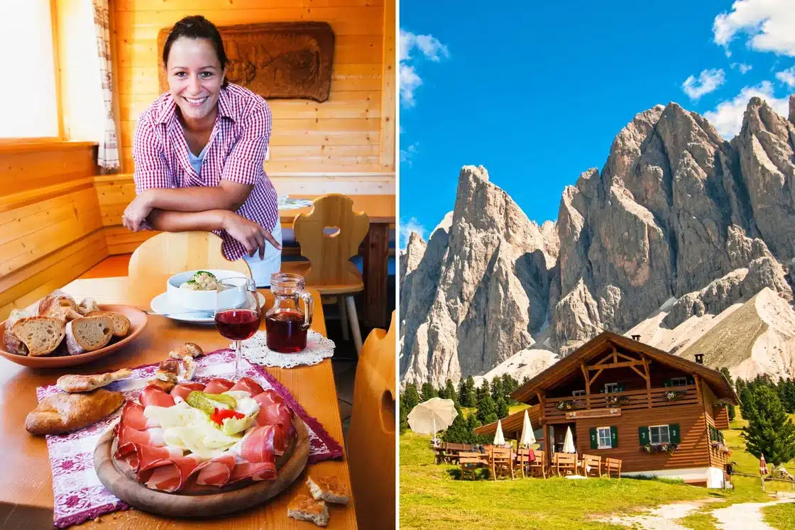 Woman smiling with plates of food in Italy next to cabin in the mountains